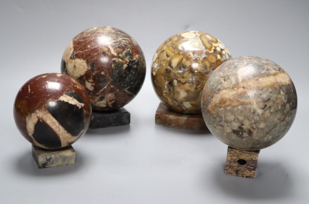 Four marble balls on stands